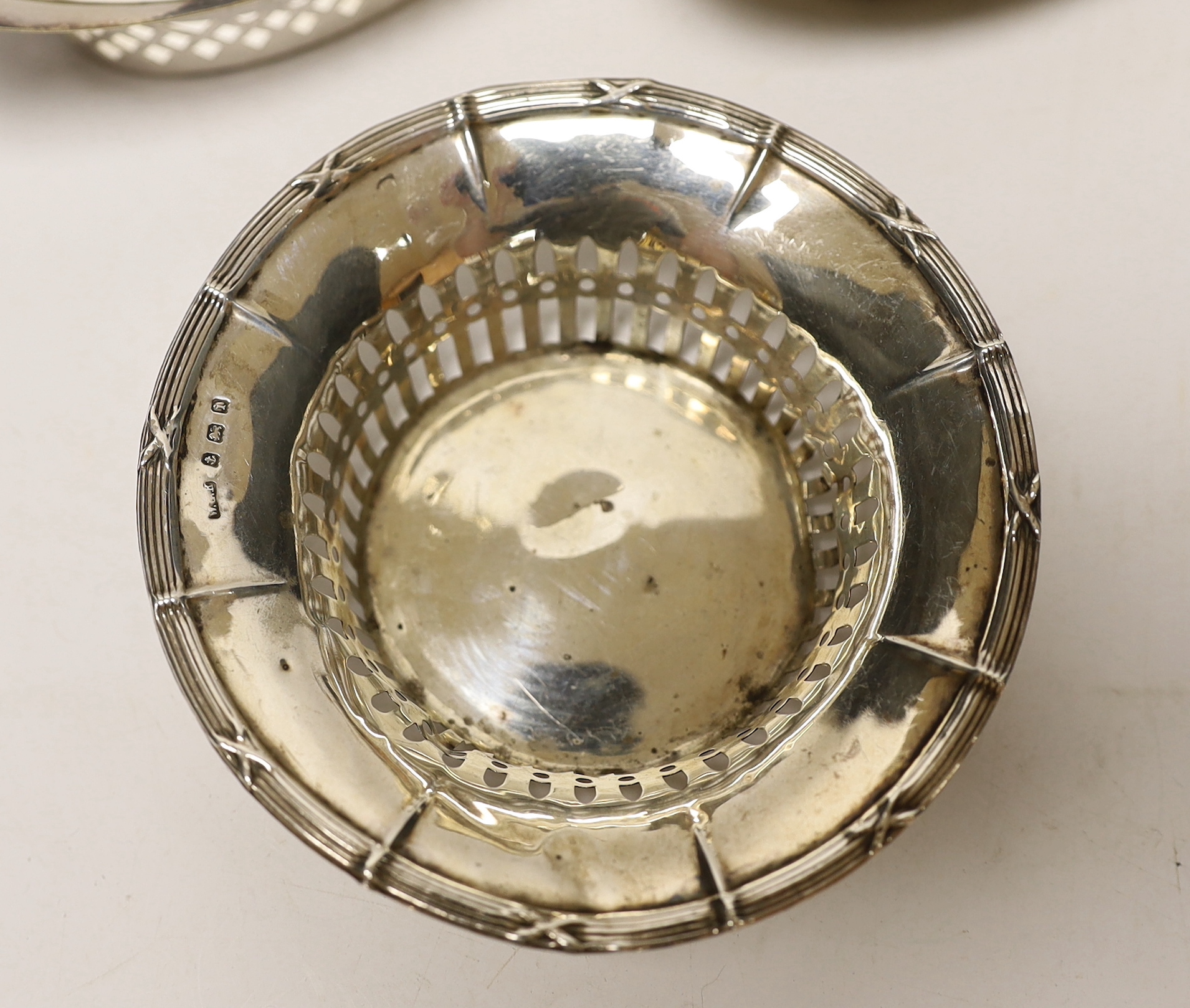 A George V silver sauce boat, three silver bonbon dishes, a small silver bowl and a Hanau white metal bowl.